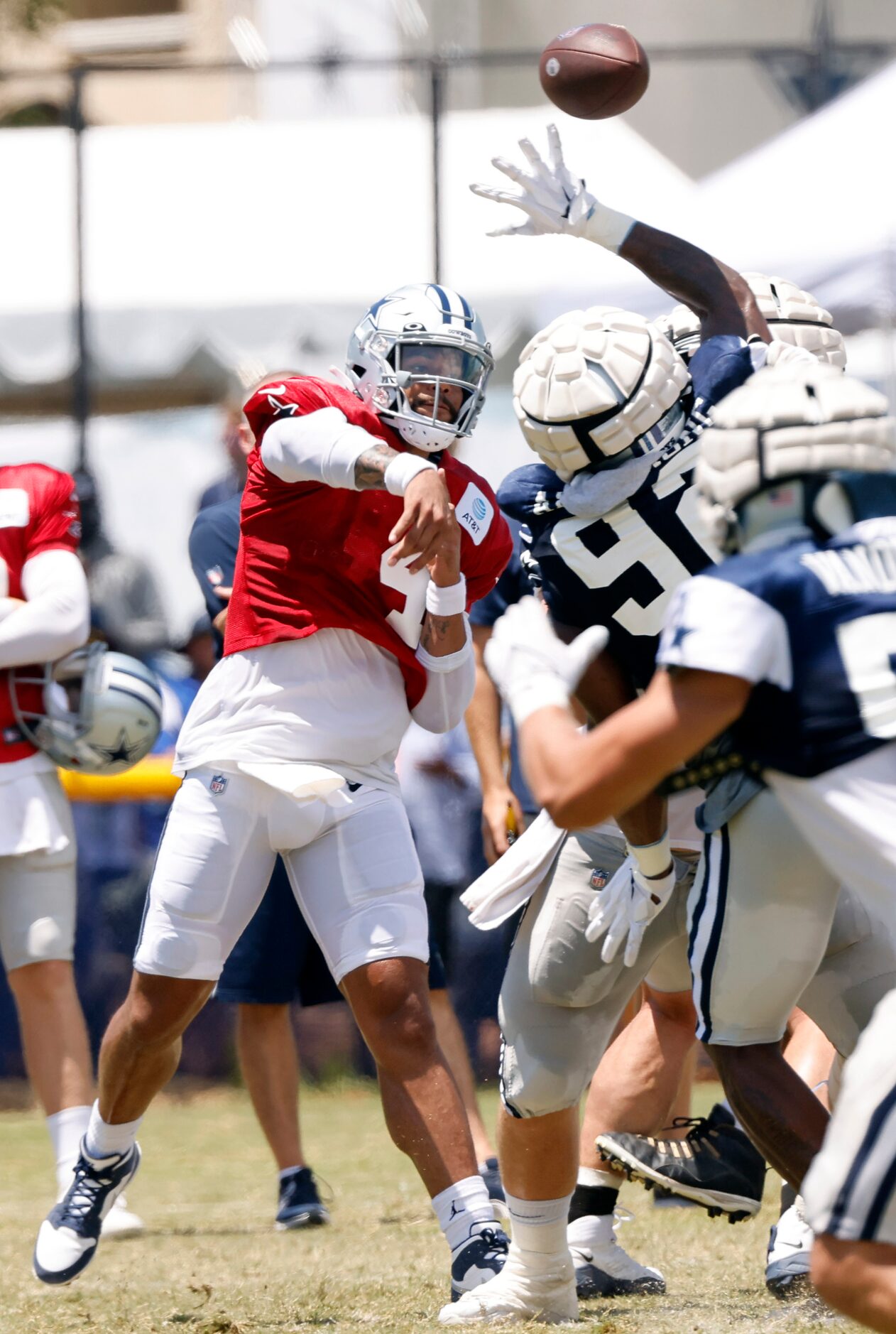 Dallas Cowboys quarterback Dak Prescott (4) throws over defensive end Dorance Armstrong (92)...