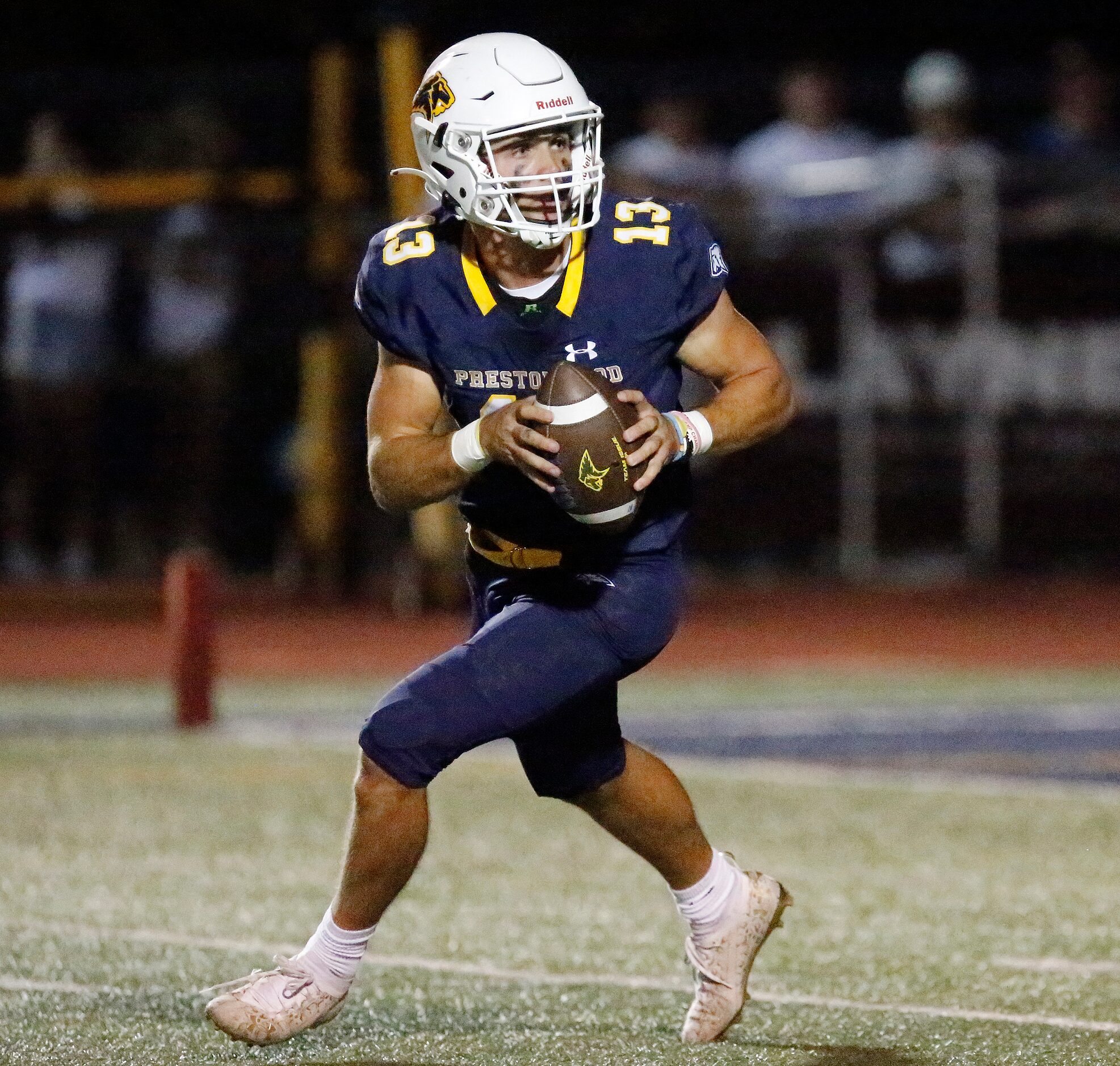 Prestonwood Christian Academy quarterback Maguire Martin (13) rolls out looking to pass...