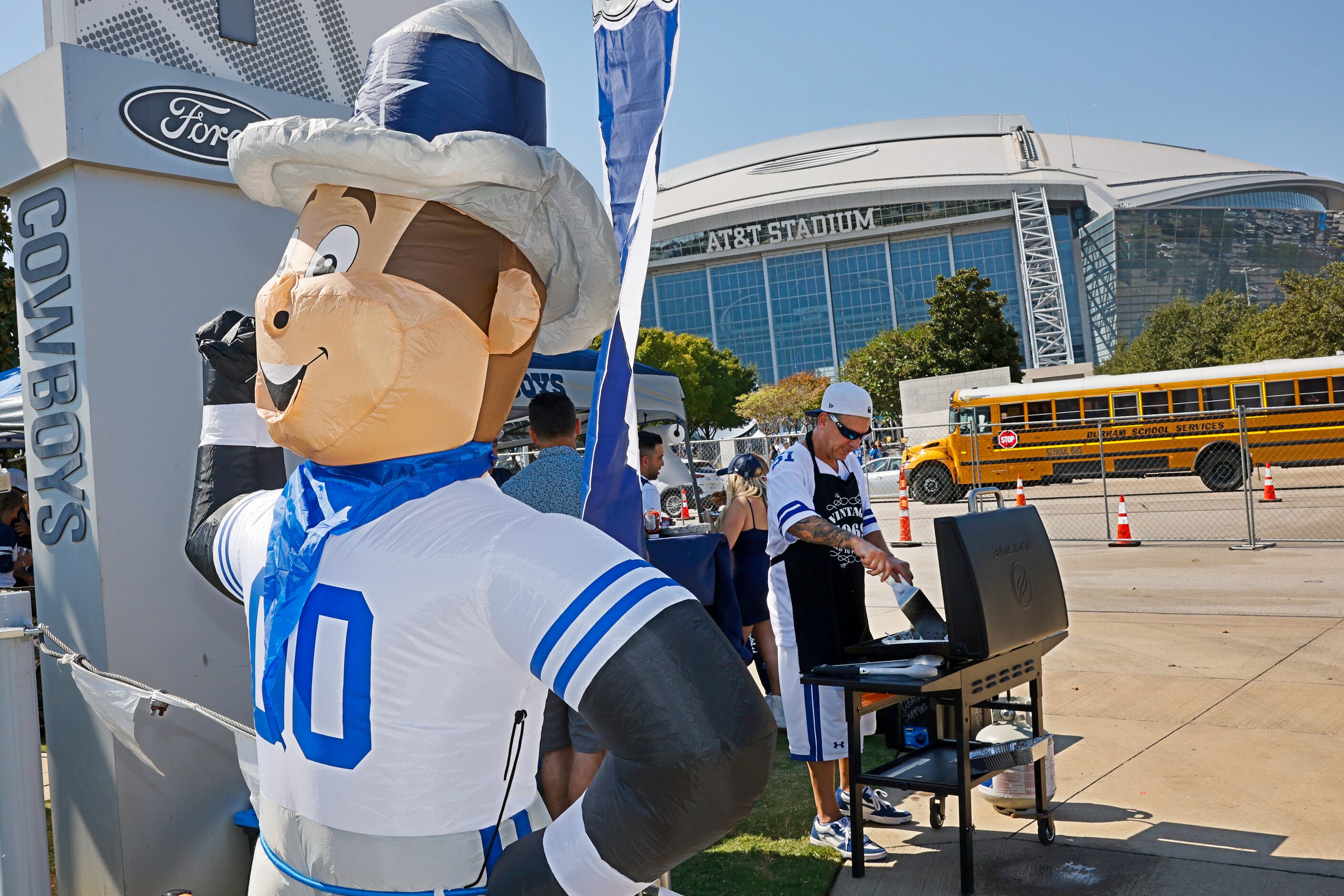 Greg Courdy of Arlington cooks while spending time tailgating before an NFL football game at...