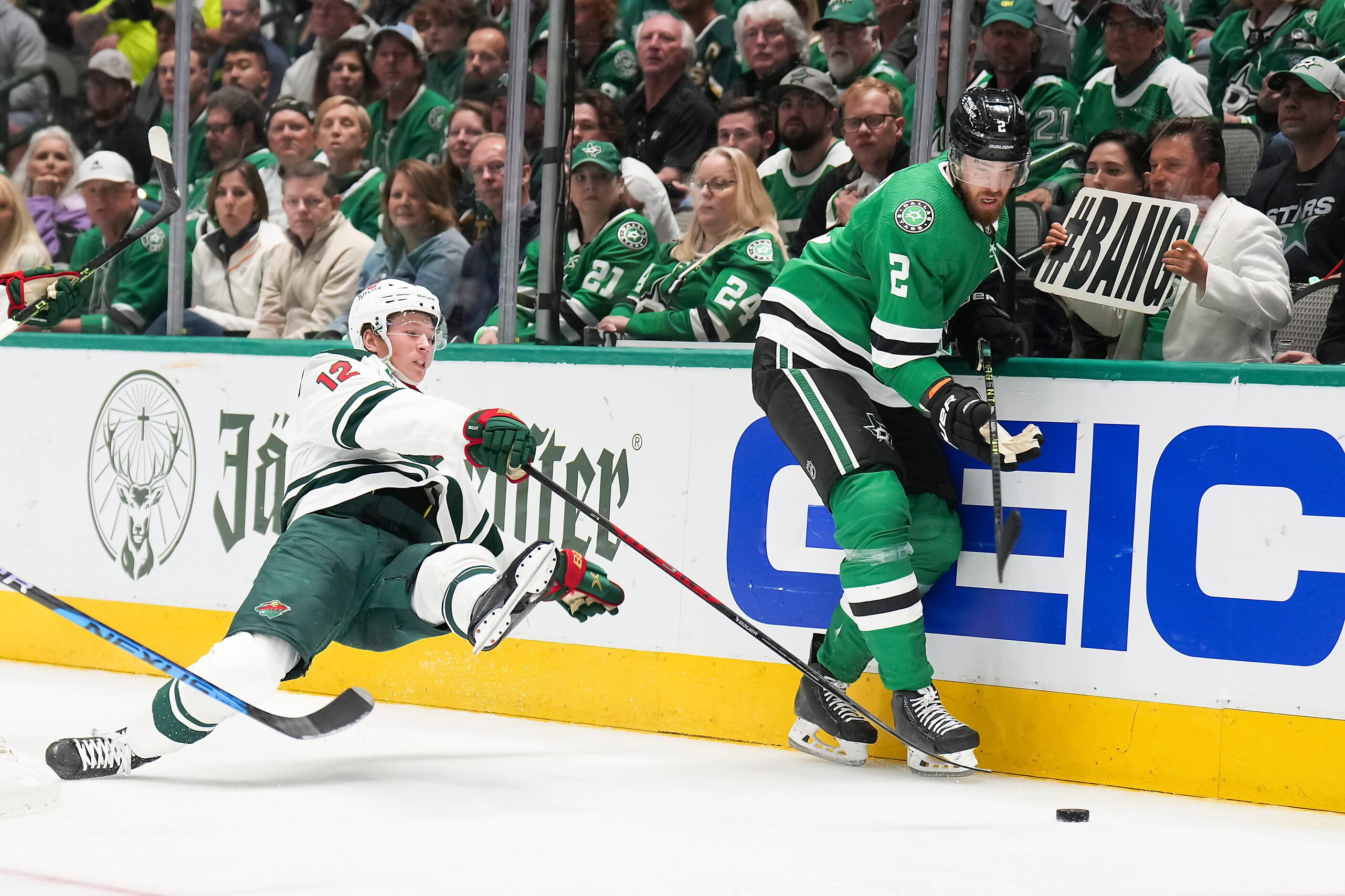 Minnesota Wild left wing Matt Boldy (12) falls to the ice as he chases the puck into the...