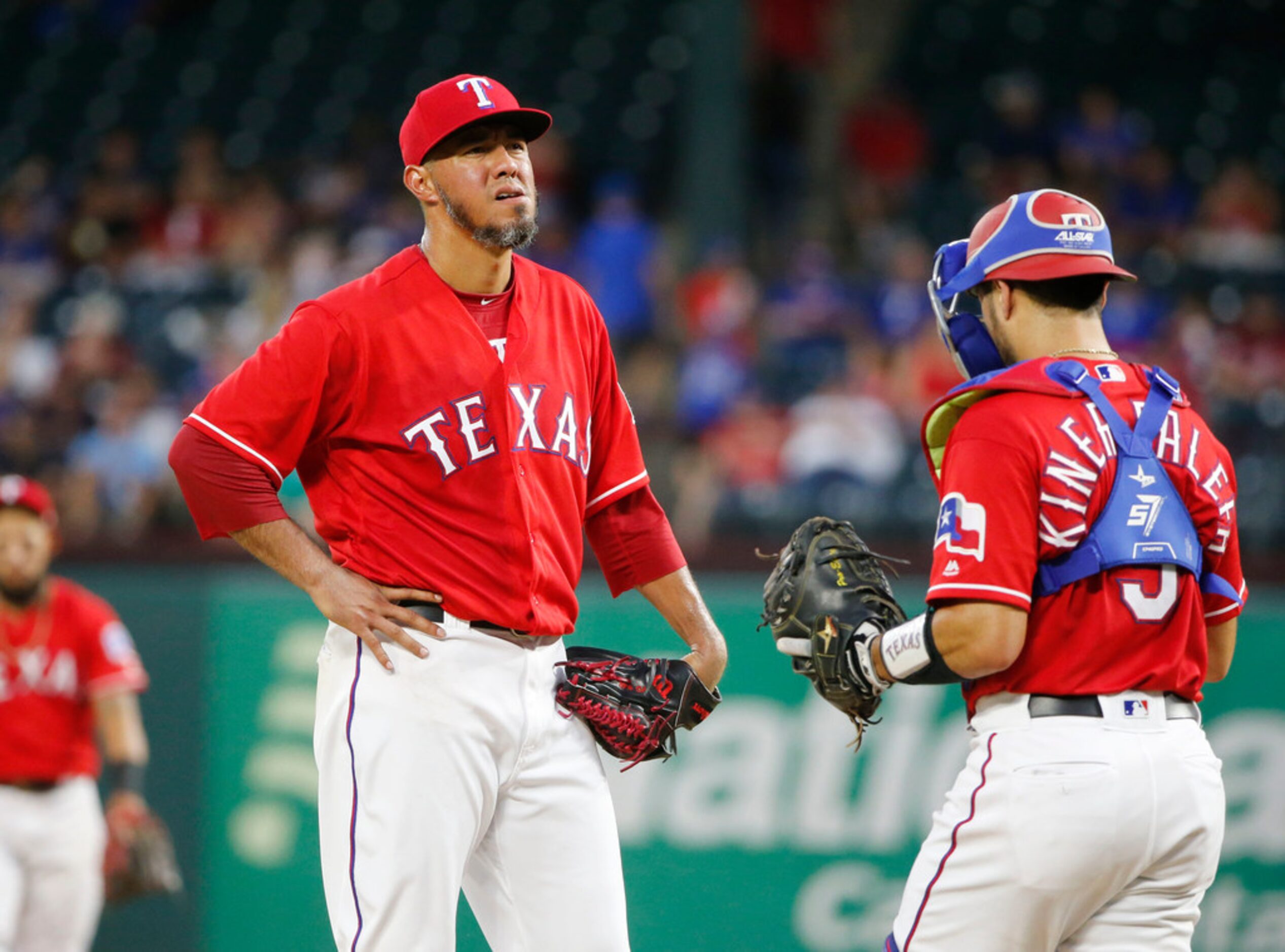 Texas Rangers starting pitcher Yovani Gallardo (49) reacts as catcher Isiah Kiner-Falefa...