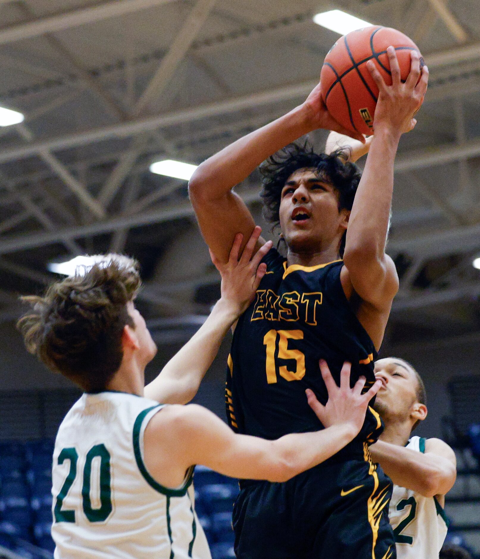 Plano East wing Izan Qazi (15) shoots over Birdville guard Brayden Schieberl (20) during the...