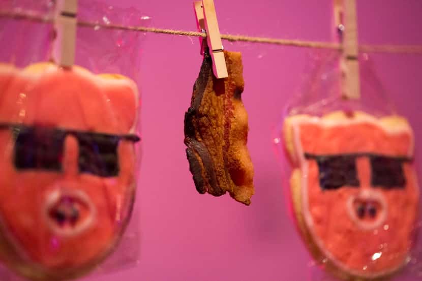 Candied bacon is served hanging from clothes pins with cookies during the Chefs for Farmers...