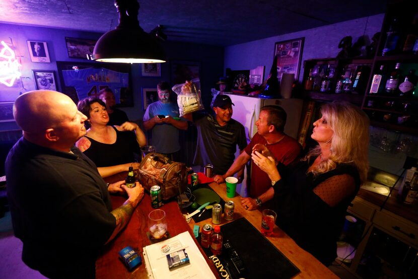 Chris Abrego holds up a bag of insulin pulled from the beer fridge as Jay Humphrey (from...