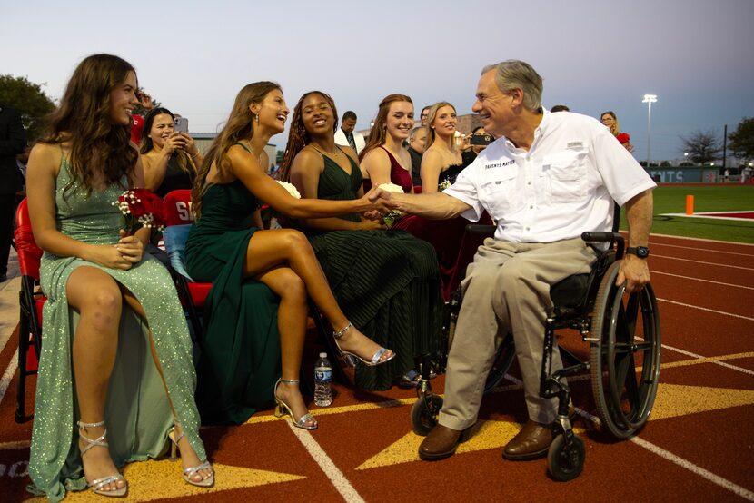 Governor Greg Abbott (right) meets homecoming court members at the First Dallas Academy...