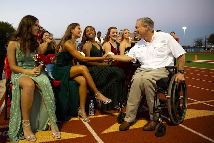 Governor Greg Abbott (right) meets homecoming court members at the First Dallas Academy...