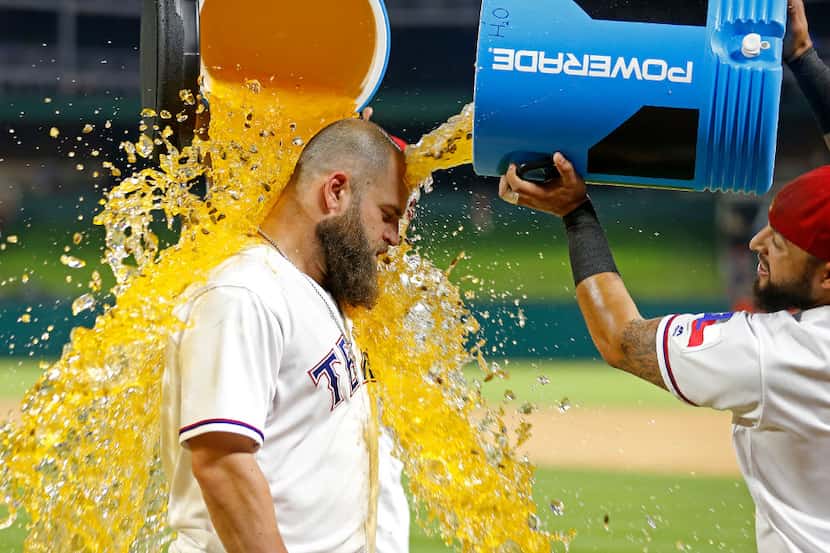 Texas Rangers first baseman Mike Napoli (5) gets doused with Gatorade by second baseman...