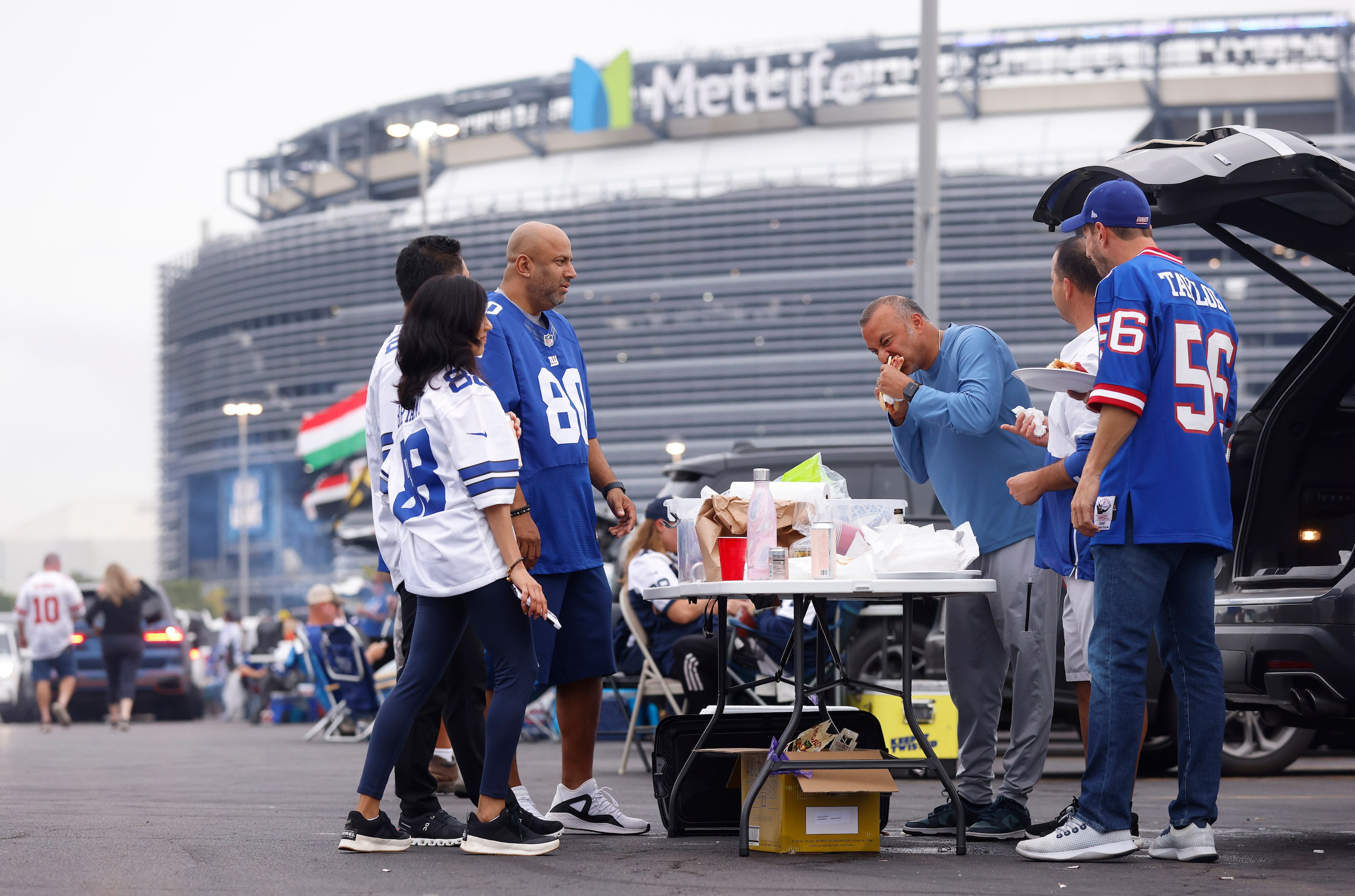 Dallas Cowboys and New York Giants fans party in the parking lot before the teams face each...