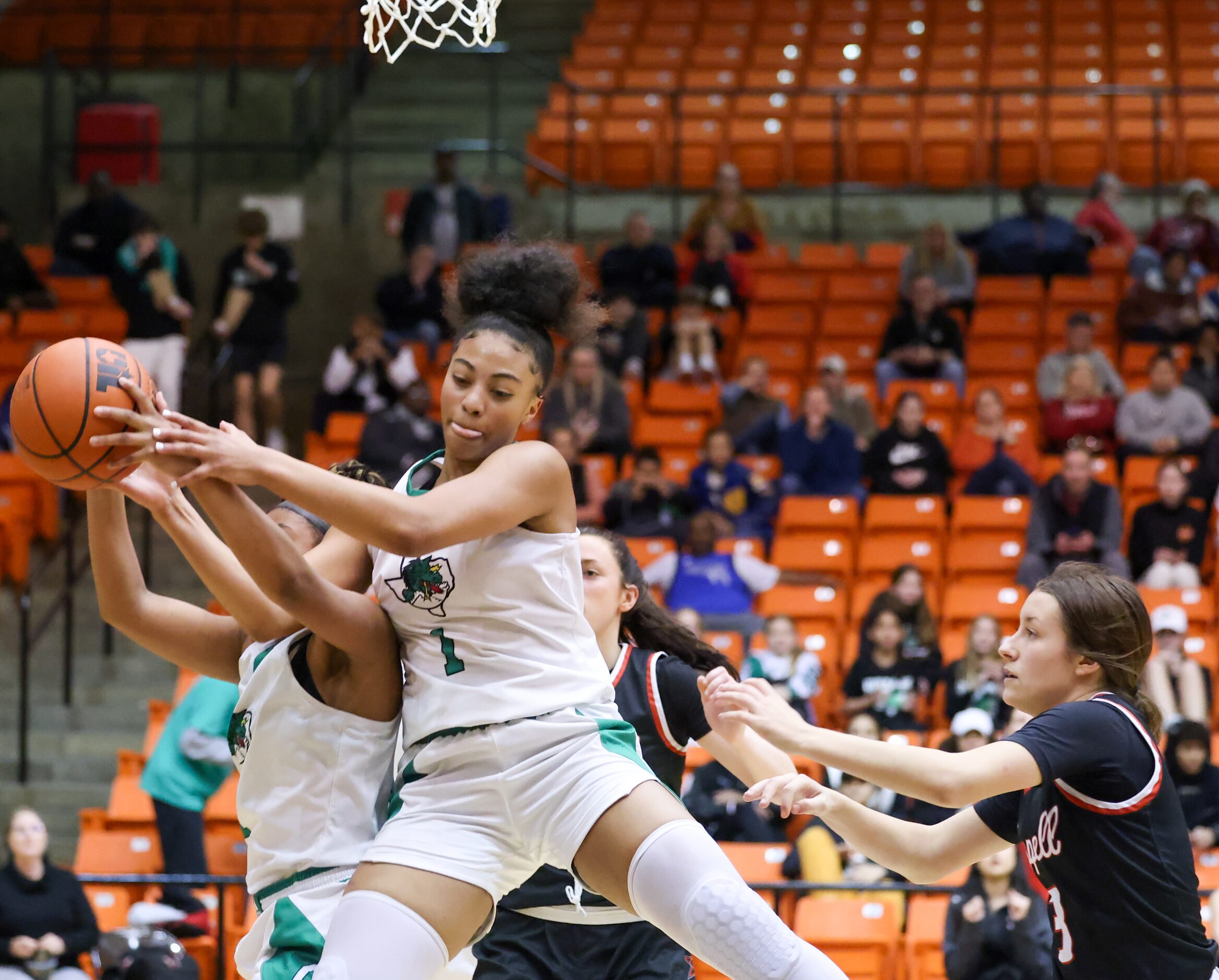 Southlake Carroll freshman guard Natalia Jordan (11, left) and sophomore guard Milania...