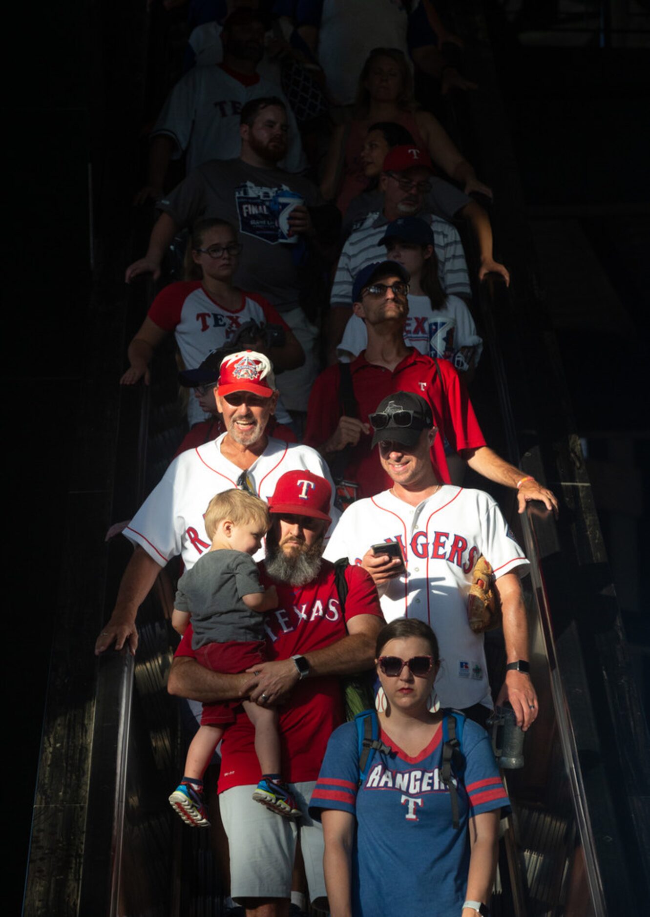 James Maples (left), carries his 2-year-old son Slate Maples, down an escalator after the...