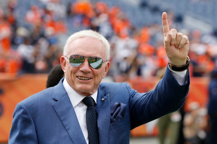 Dallas Cowboys owner and general manager Jerry Jones waves to the fans before a game between...