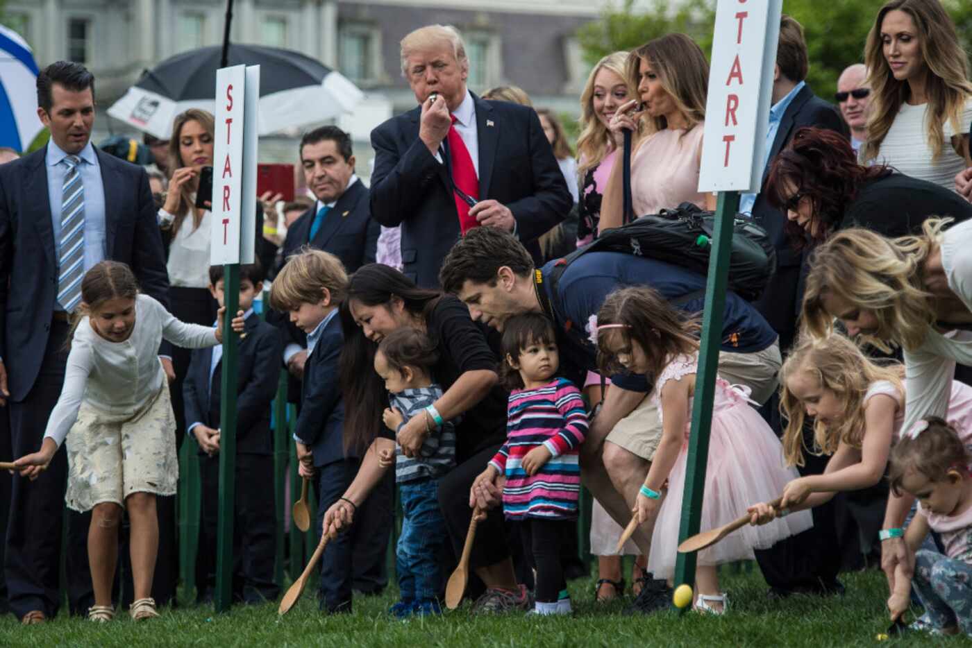 President Donald Trump and first lady Melania Trump blow whistles to begin an Easter Egg...