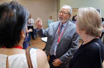 Randy Routon, CEO of LifePath Systems, answers questions as visitors tour the LifePath...