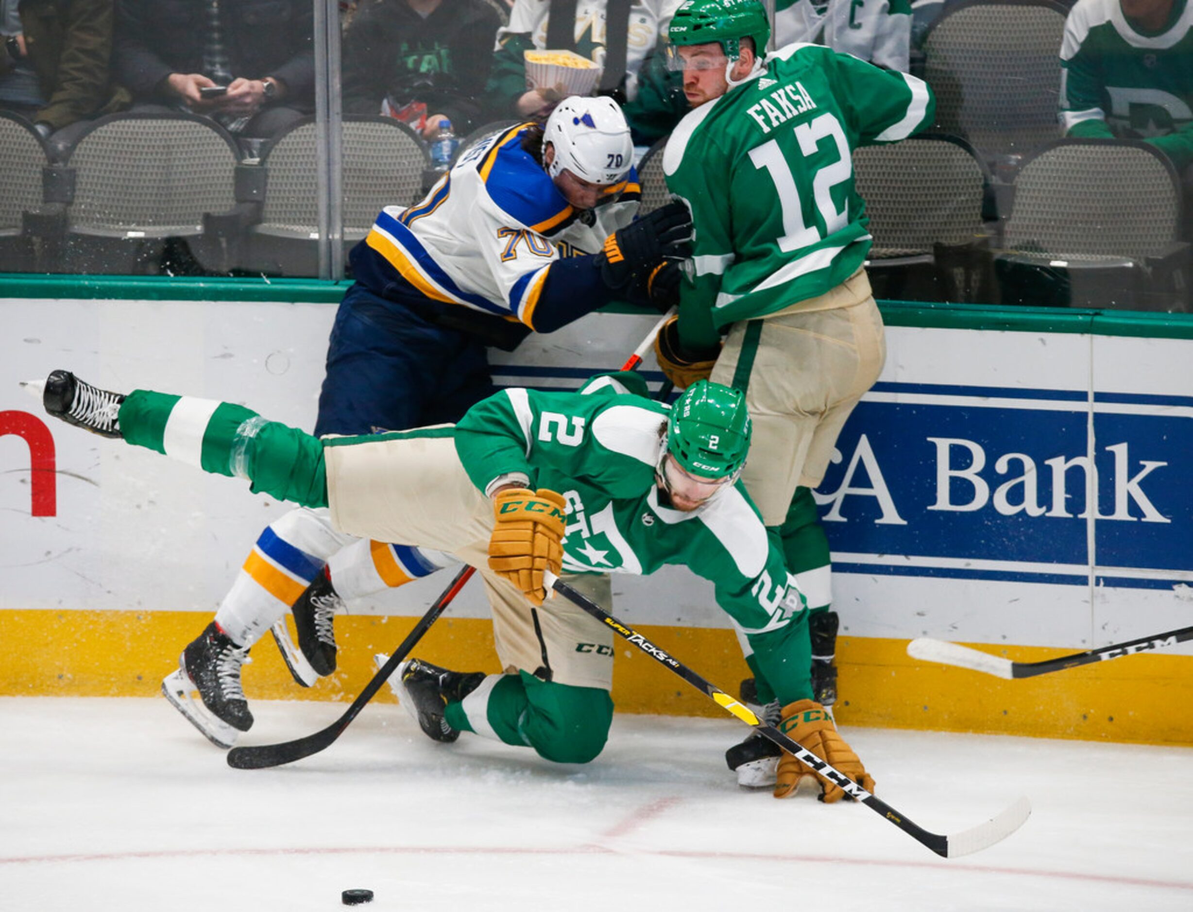 Dallas Stars defenseman Jamie Oleksiak (2) goes down to the ice while battling against St....