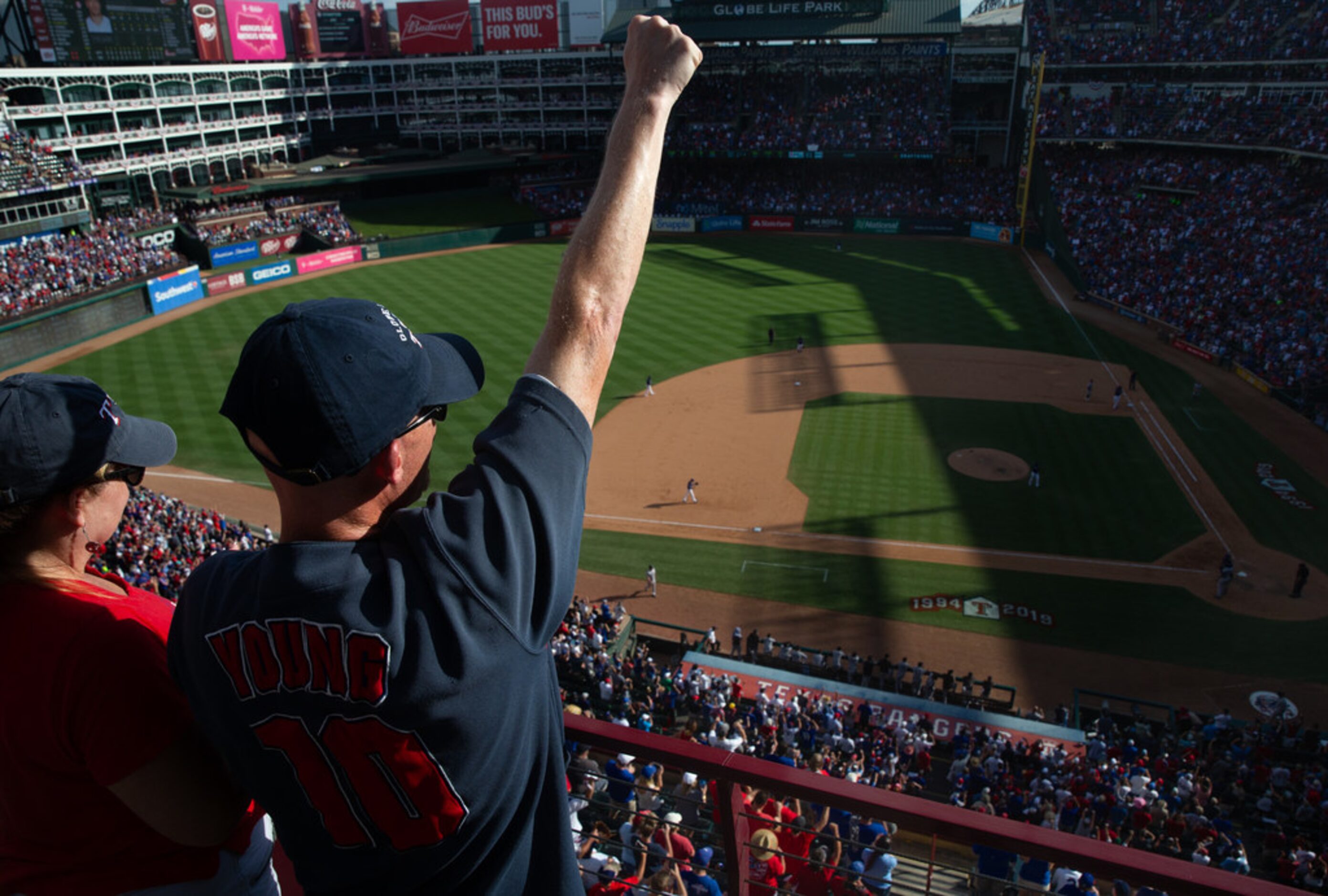 Fans celebrate during the Texas Rangers' final out during their last game ever played at...