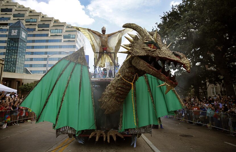 Mateo Vences spreads his wings atop a large dragon on the Club Kaliente float in the Alan...