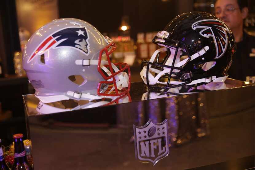 IMAGE DISTRIBUTED FOR NFL - New England Patriots and Atlanta Falcons football helmets are on...