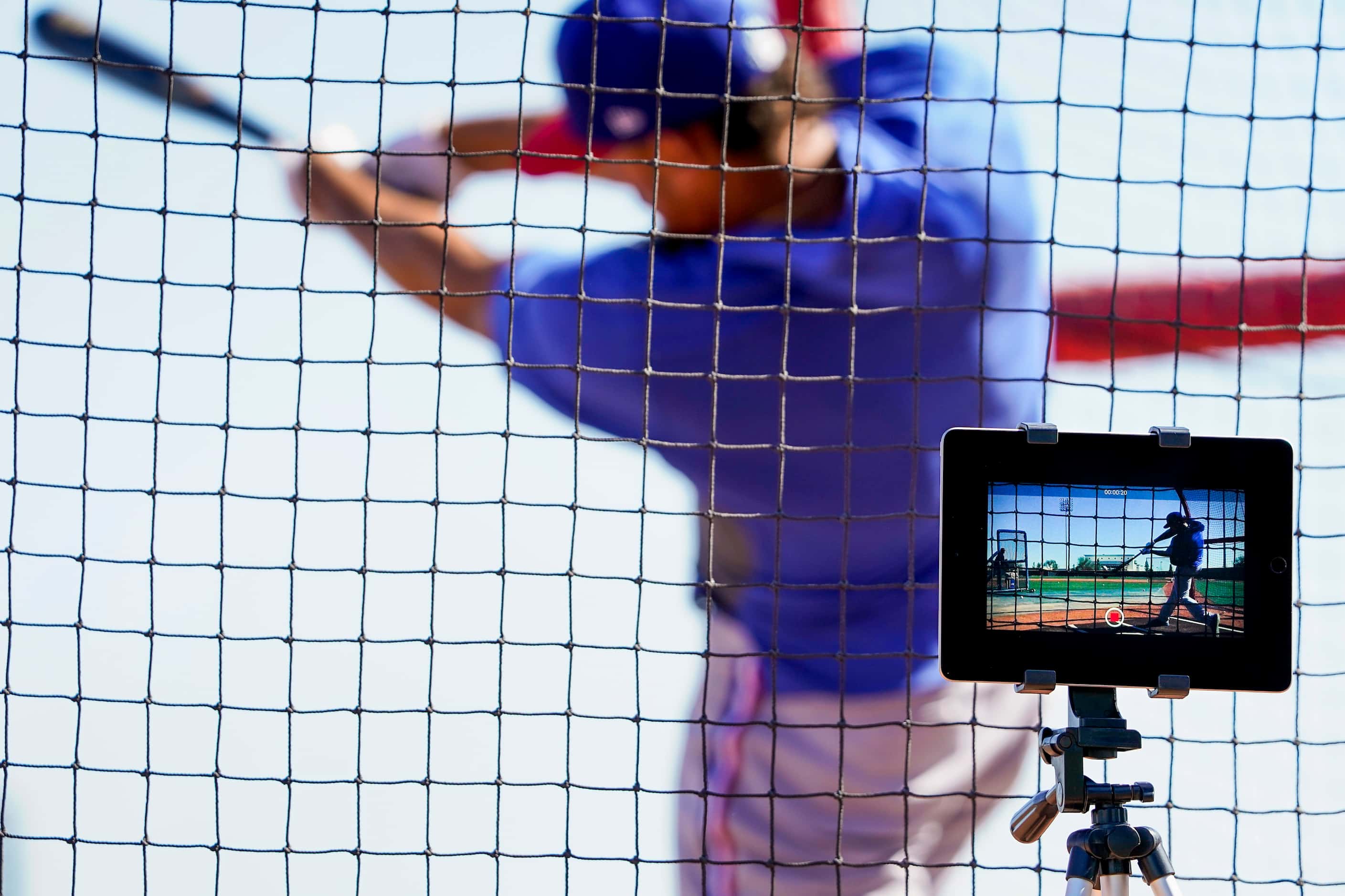 A tablet set up by Texas Rangers assistant hitting coach Callix Crabbe records outfielder...