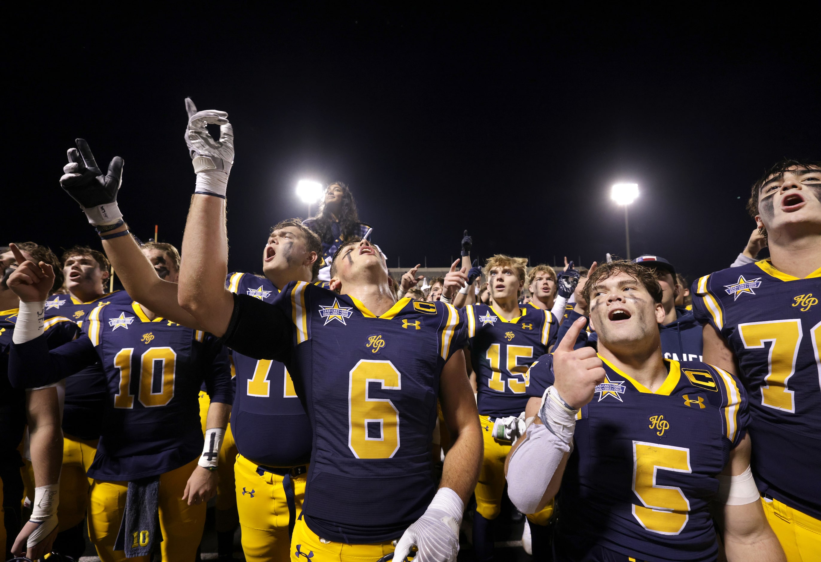 Highland Park players celebrate after winning an area round high school football playoff...