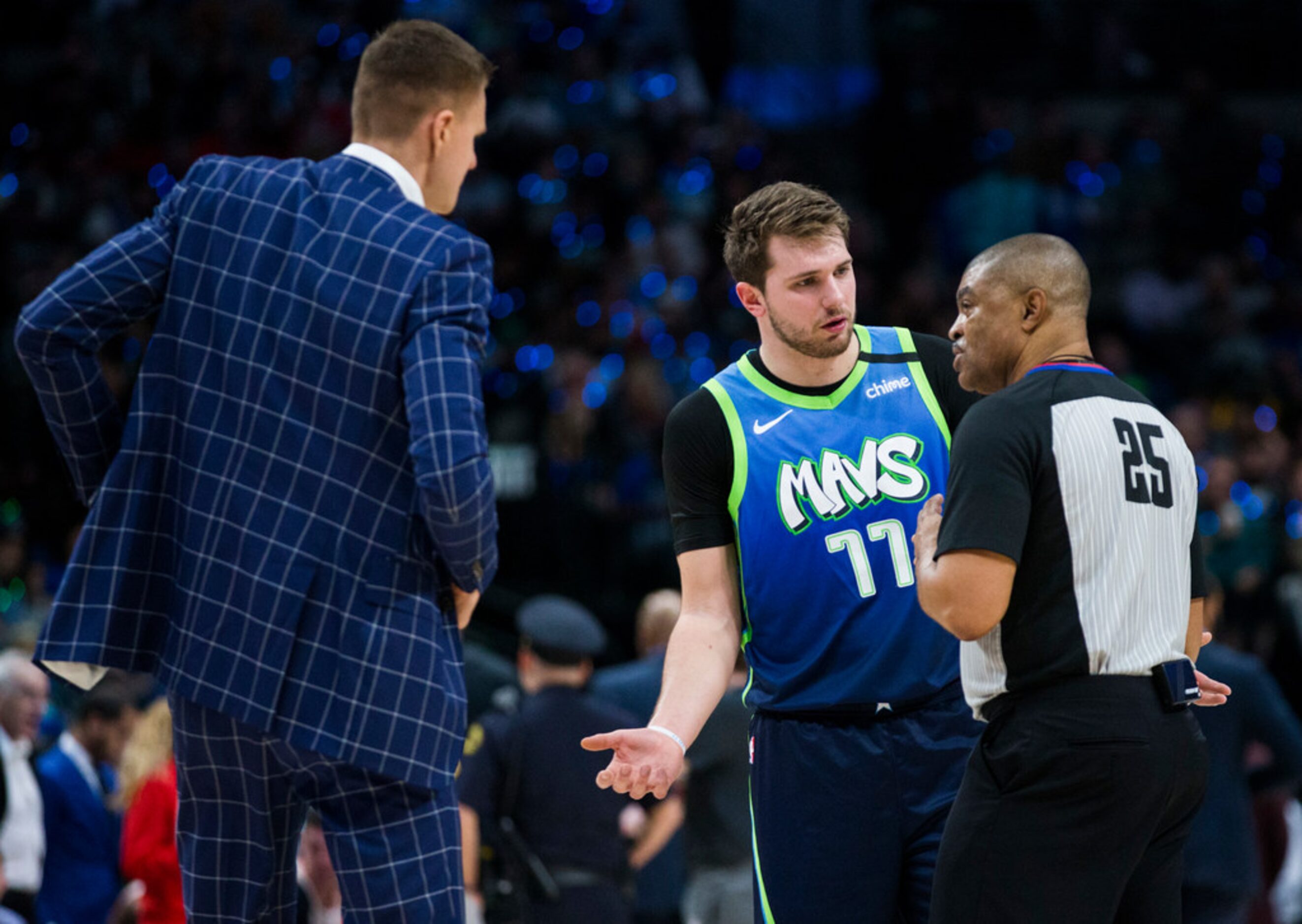 Dallas Mavericks forward Luka Doncic (77) and forward Kristaps Porzingis (6) question an...