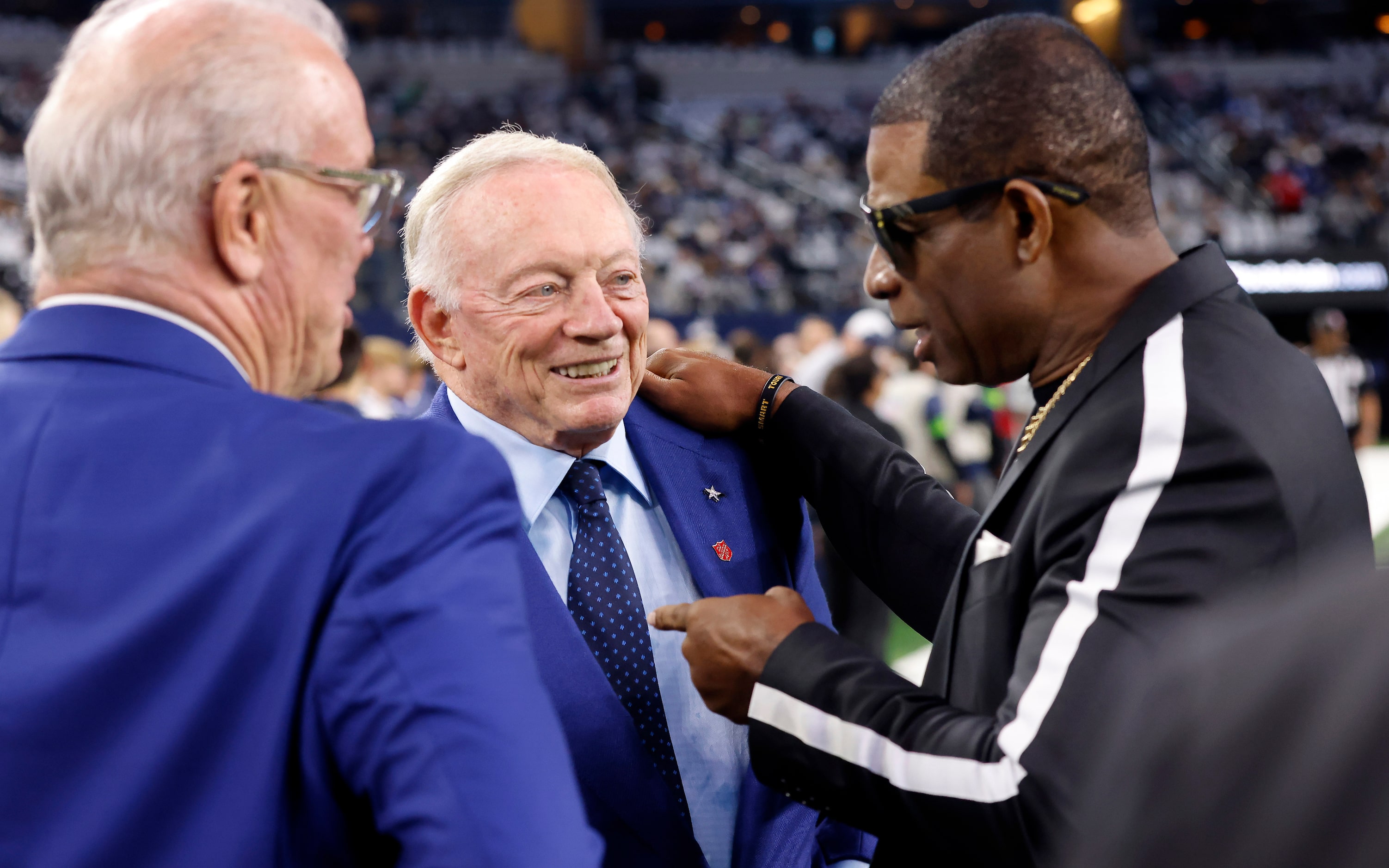 Former Dallas Cowboys player and current University of Colorado coach Deion Sanders (right)...