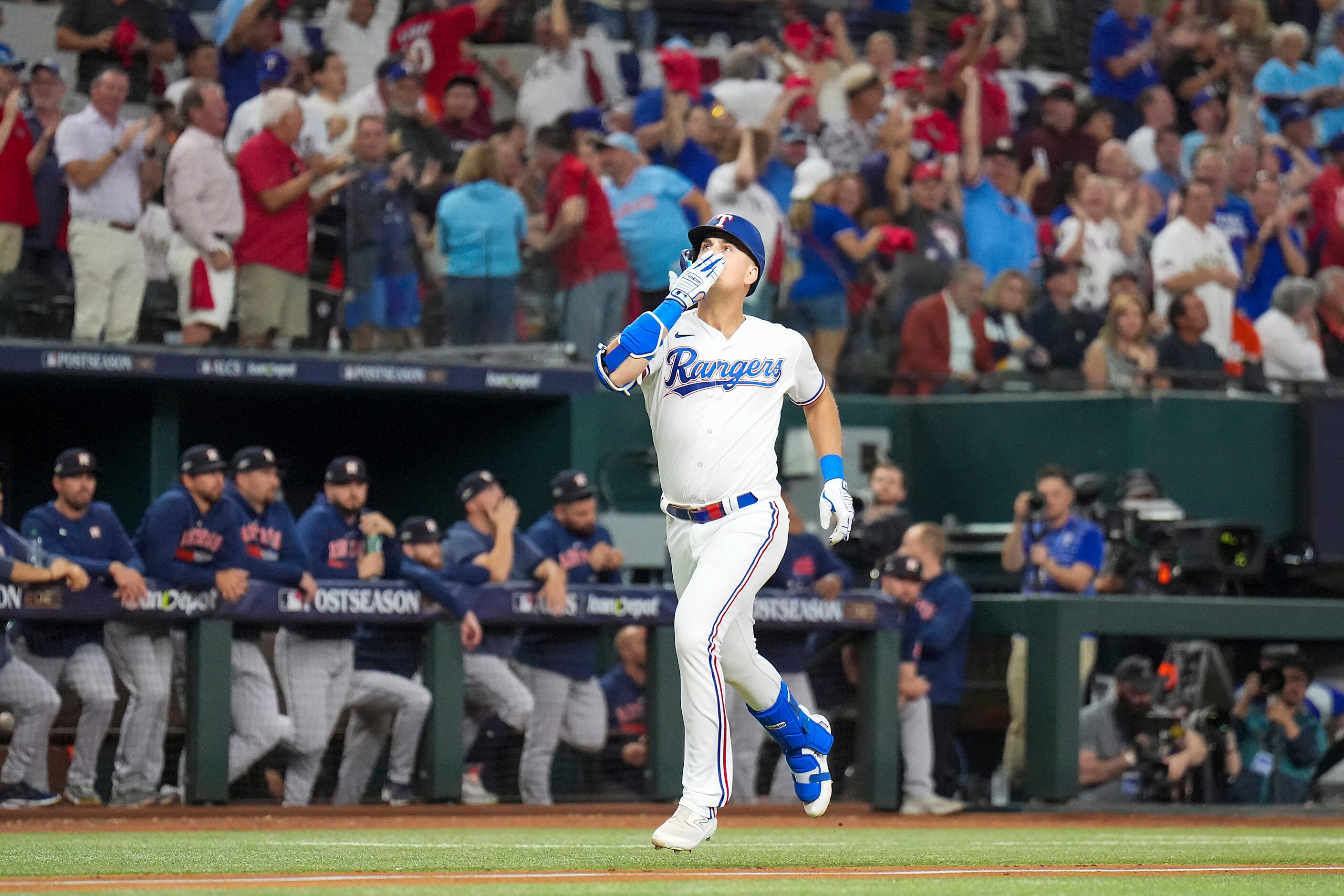 Texas Rangers first baseman Nathaniel Lowe celebrates as he rounds the bases after hitting a...