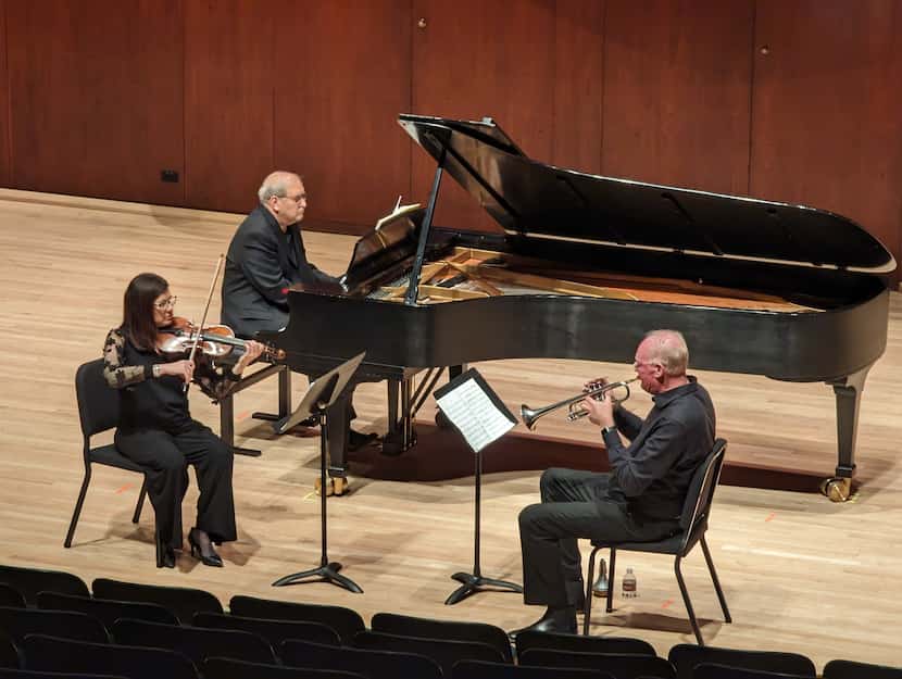 Violinist Maria Schleuning, trumpeter John Holt and pianist Steven Harlos play the Trio in...
