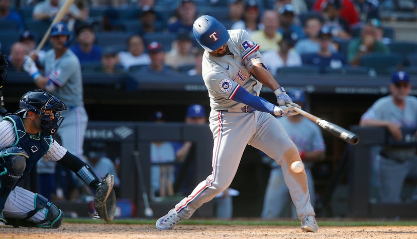 Texas Rangers' Marcus Semien strikes out to lead off the ninth inning during a baseball game...