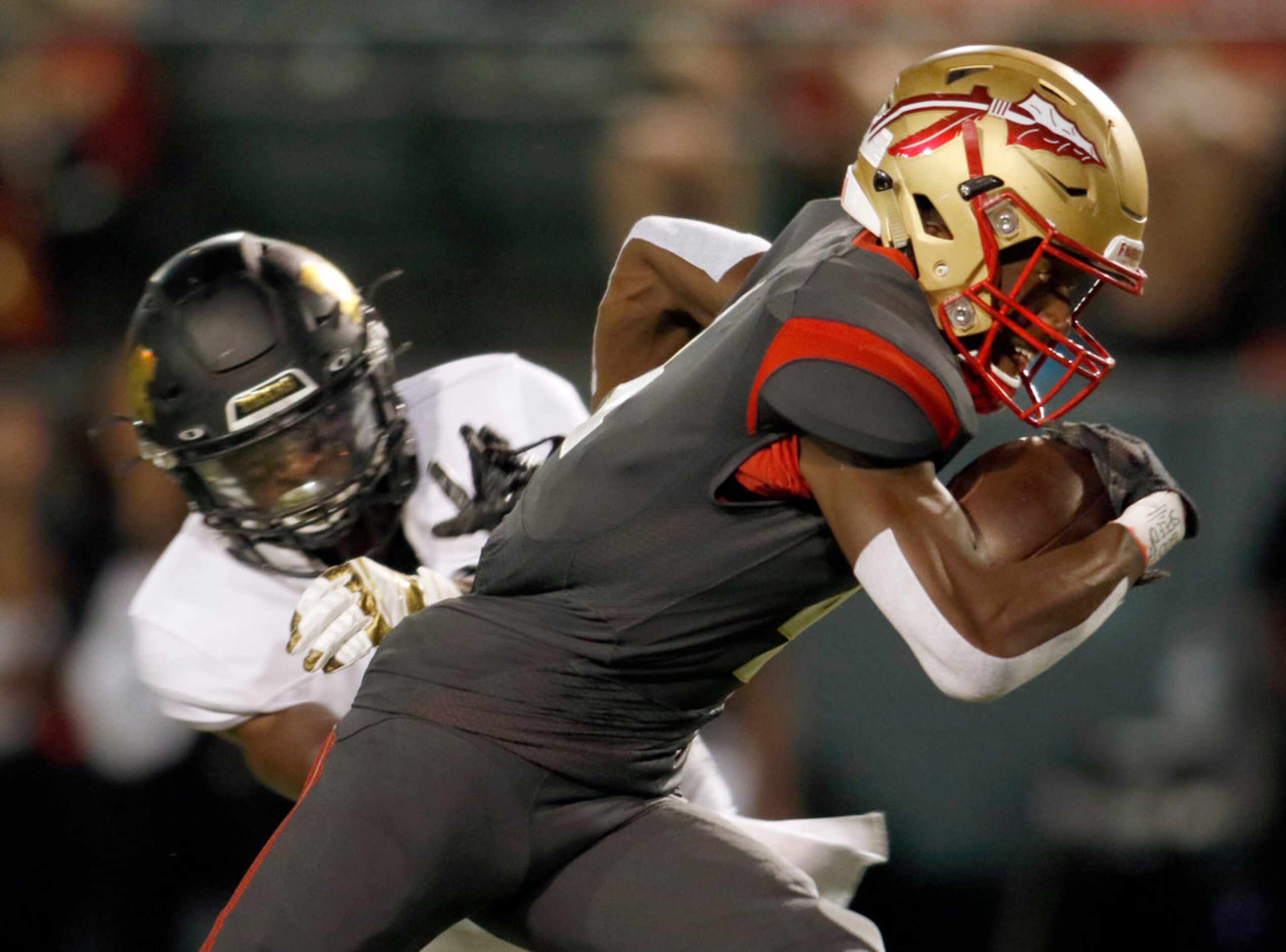 South Grand Prairie receiver Josh Nicholson (4) tacks on extra yardage after pulling in a...