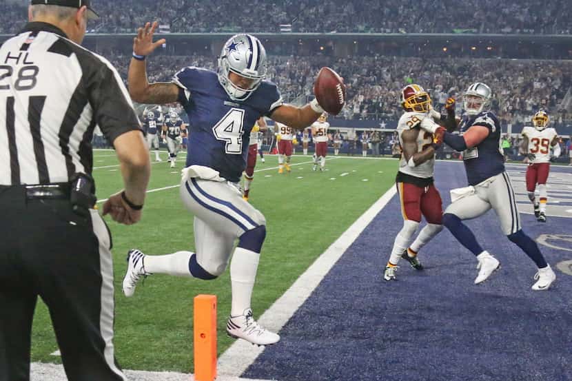 Dallas Cowboys quarterback Dak Prescott (4) scores on a fourth-quarter touchdown run in...