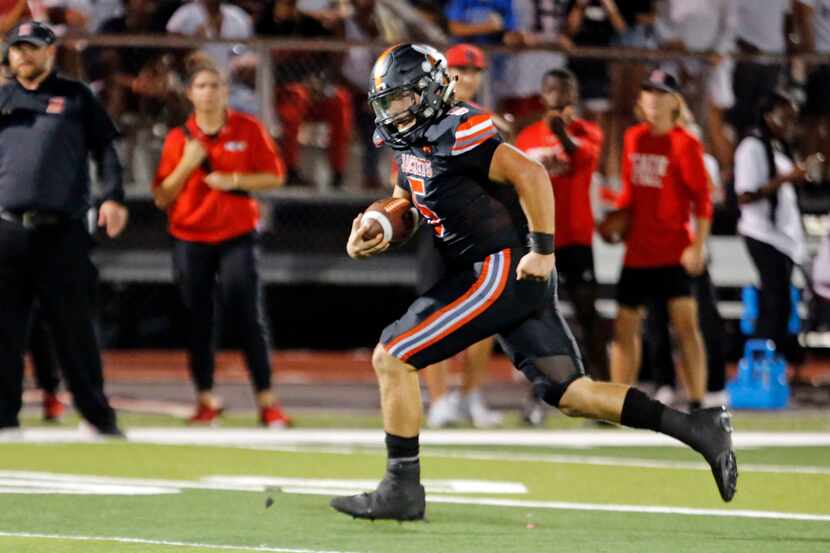 Rockwall high QB Lake Bennett (5) take set ball to the end zone for a second tome on a trick...