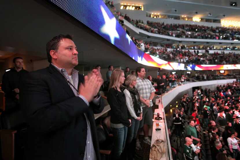 Dallas Stars owner Tom Gaglardi claps during the announcement of the Stars active military...