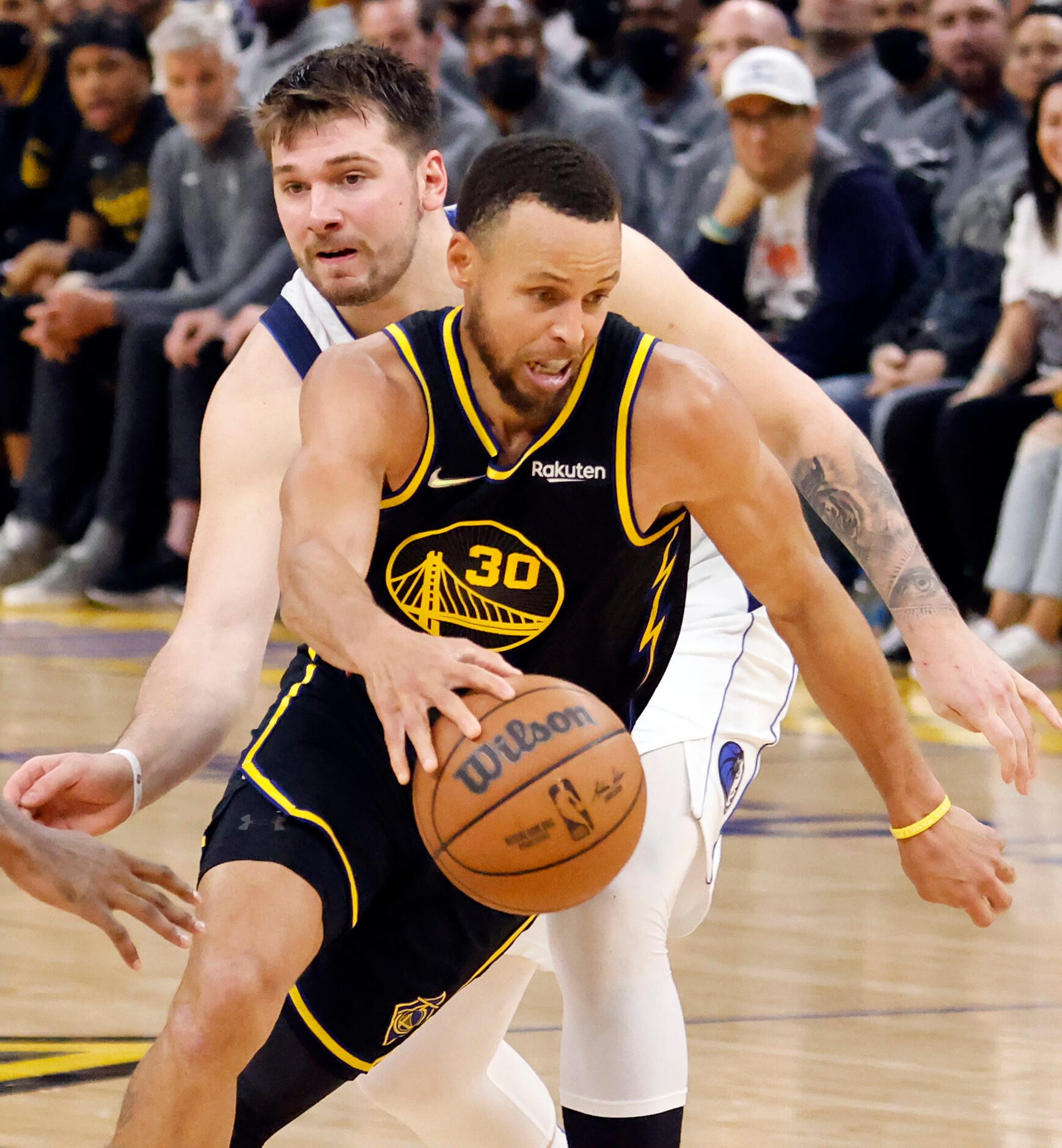 Dallas Mavericks guard Luka Doncic (77) tries to reach around Golden State Warriors guard...