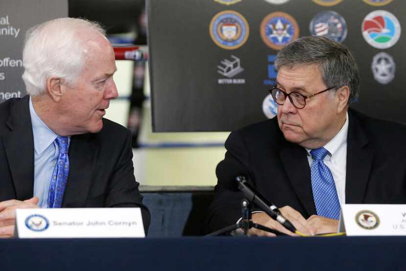 Sen. John Cornyn (left) talked with Attorney General William Barr during a news conference...