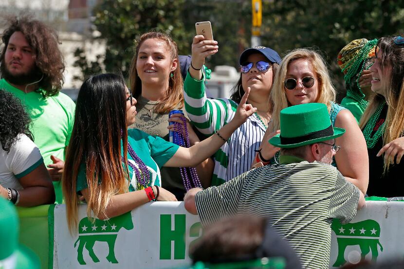 People ride a float during last year's St. Patrick's Day Parade on Greenville Avenue in Dallas.