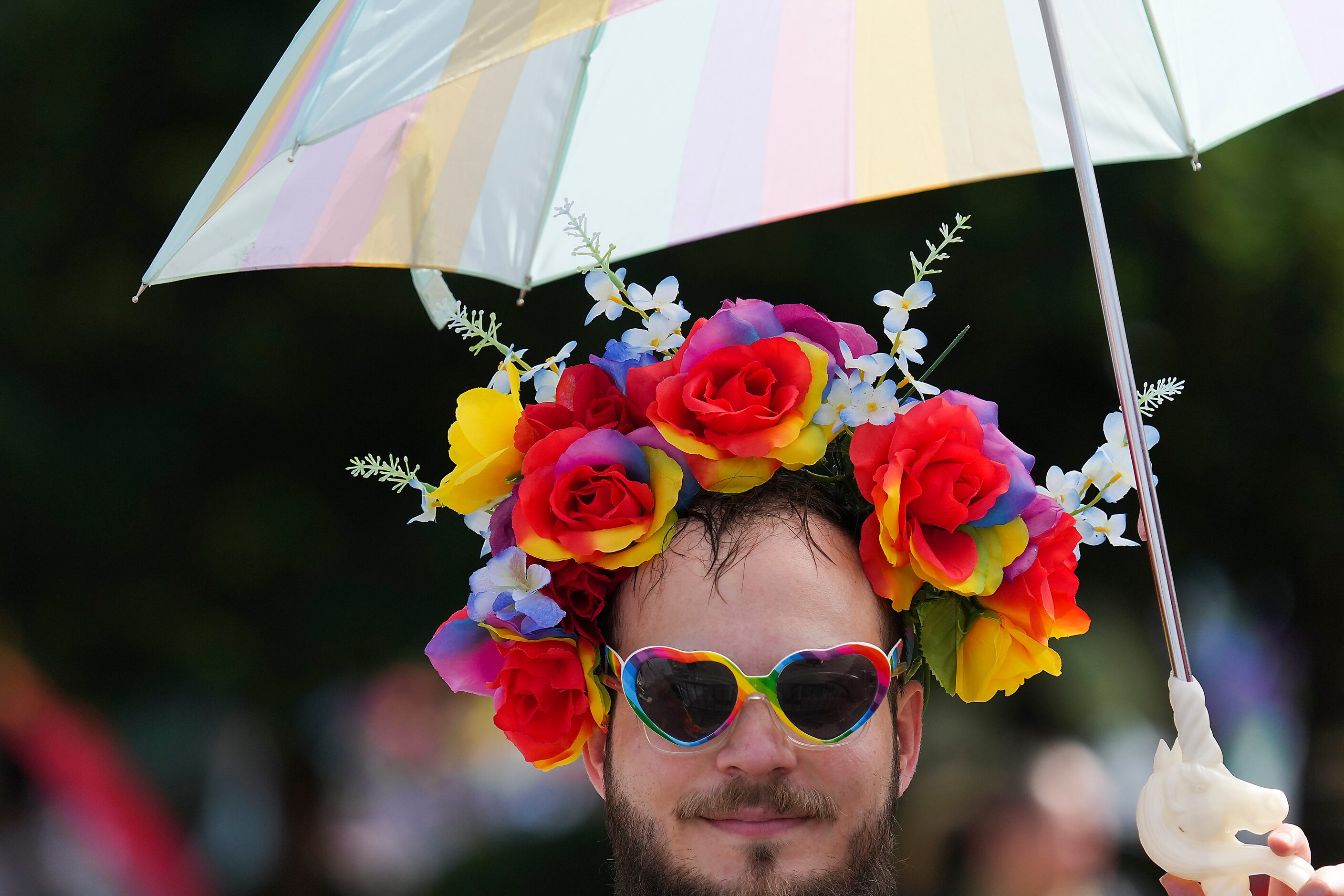 Spectator Ben Borst watches as participants move through through Fair Park during the annual...