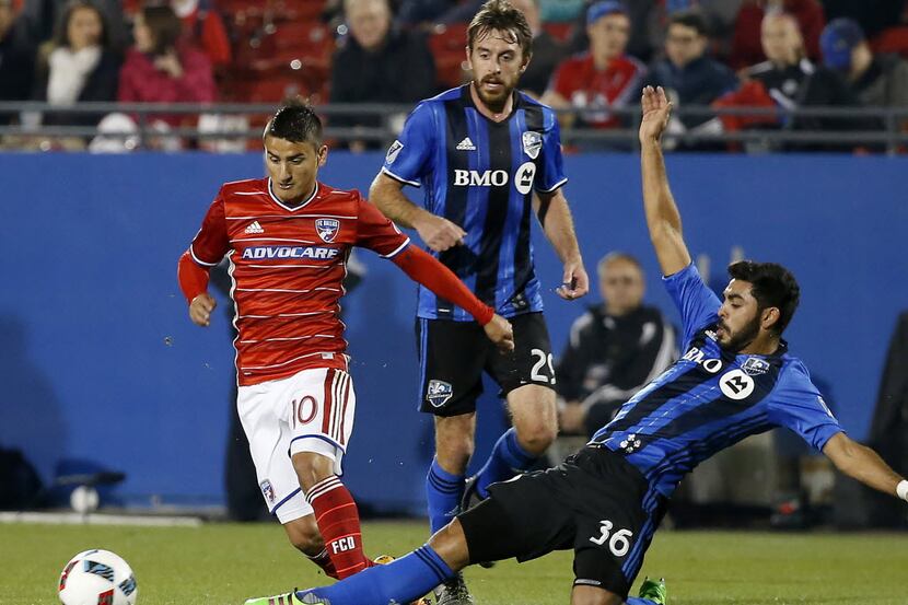 FC Dallas midfielder Mauro Diaz (10) avoids a tackle by Montreal Impact defender Victor...
