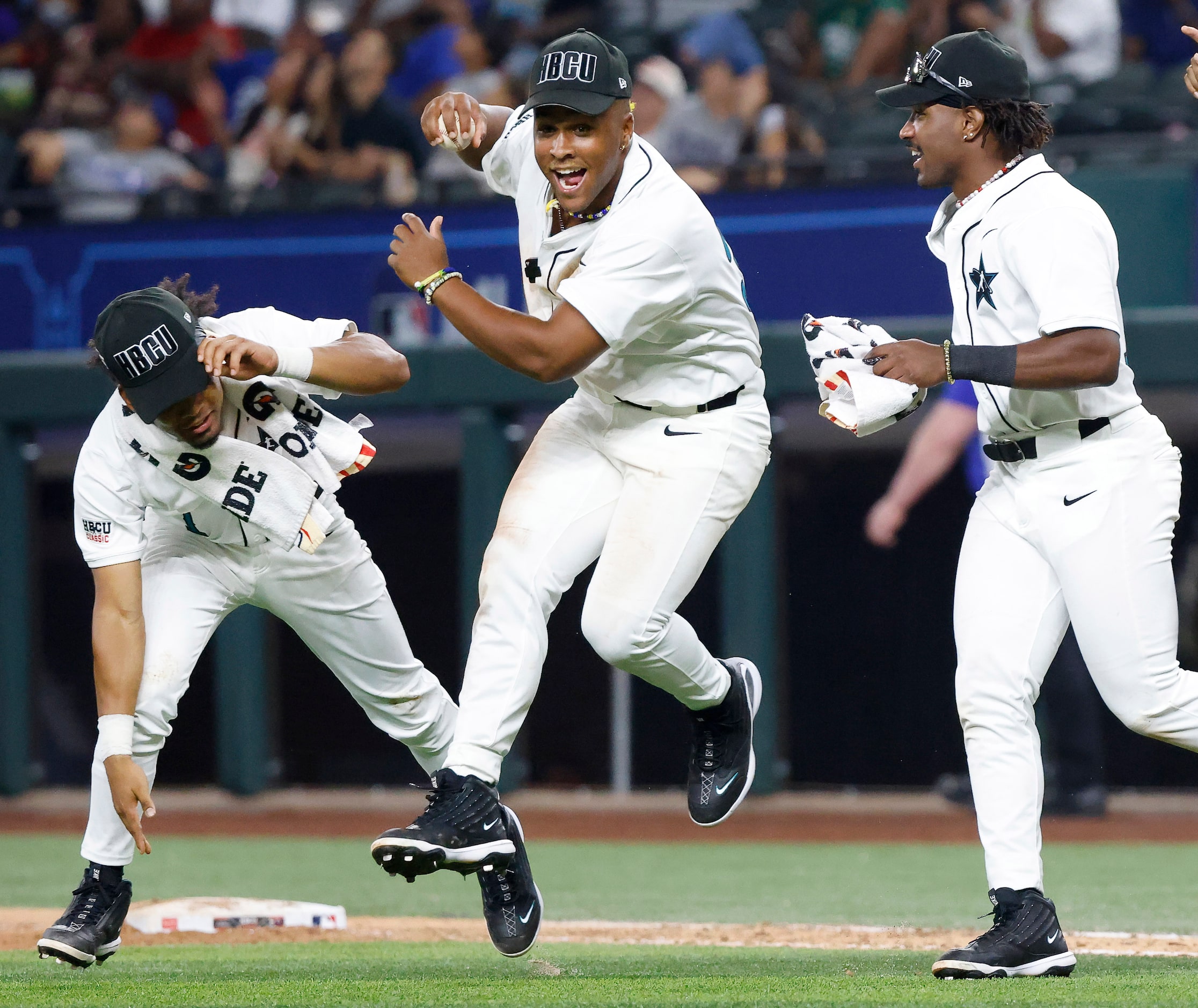 American League players Tiger Borom (left) and Ty Jackson (center) celebrate their HBCU...