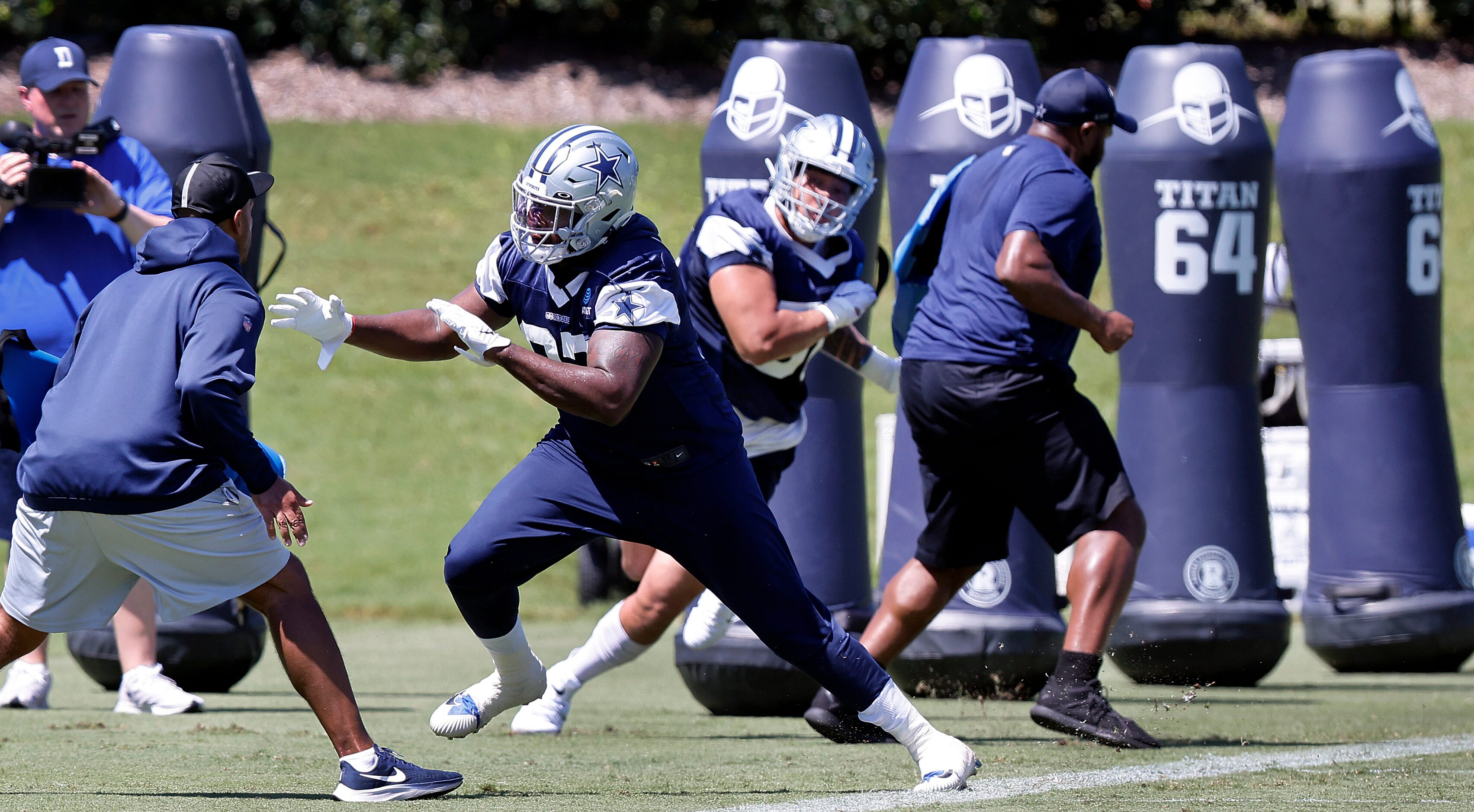 Dallas Cowboys defensive ends Ron'Dell Carter (center) and defensive end Bradlee Anae (56)...