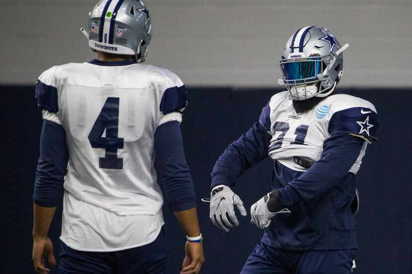 Dallas Cowboys running back Ezekiel Elliott (21) celebrates a play alongside quarterback Dak...