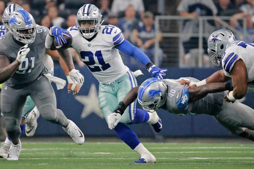Dallas Cowboys running back Ezekiel Elliott (21) breaks through the line on a long third...