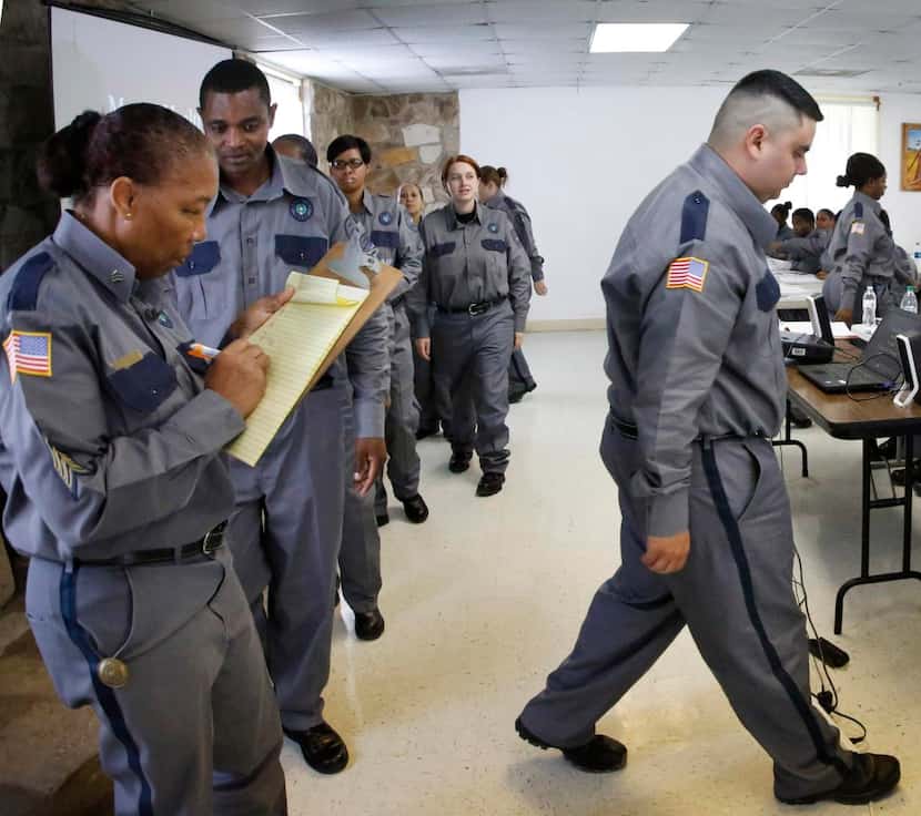 
Sgt. Sylvia Norman (left) records information as Texas Department of Corrections officer...