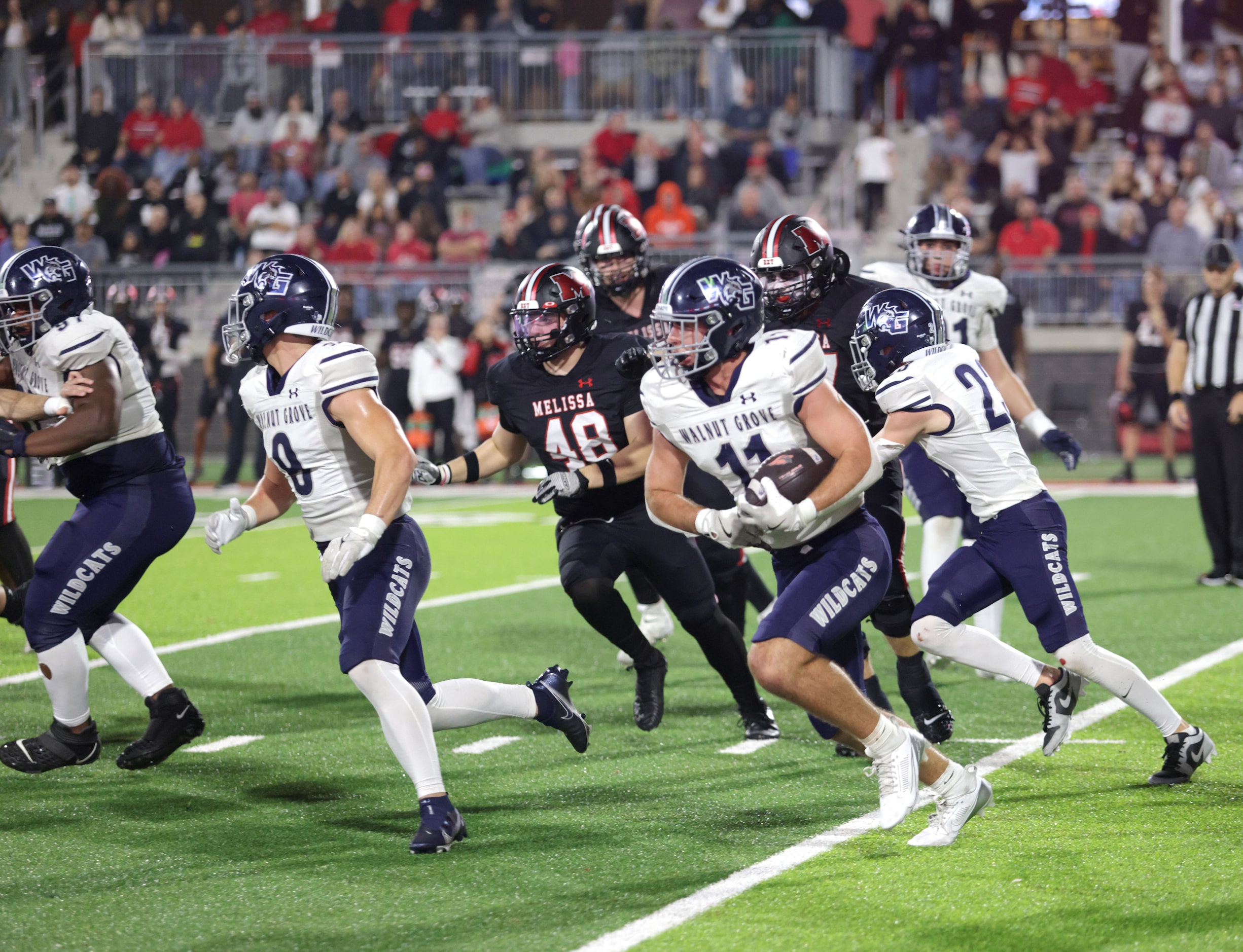 Walnut Grove player #11 Keller Pittenger runs the ball after recovering a blocked kick...