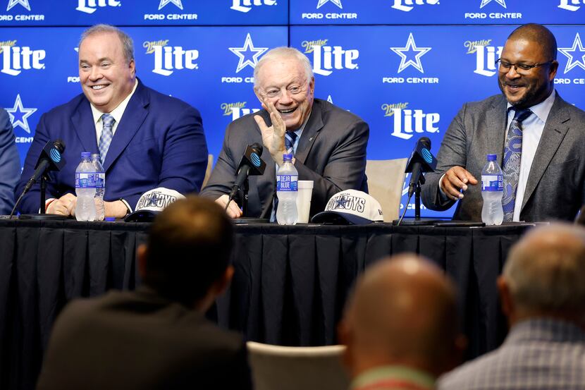 Dallas Cowboys owner Jerry Jones (cetner) jokes with the media as he discusses their first...