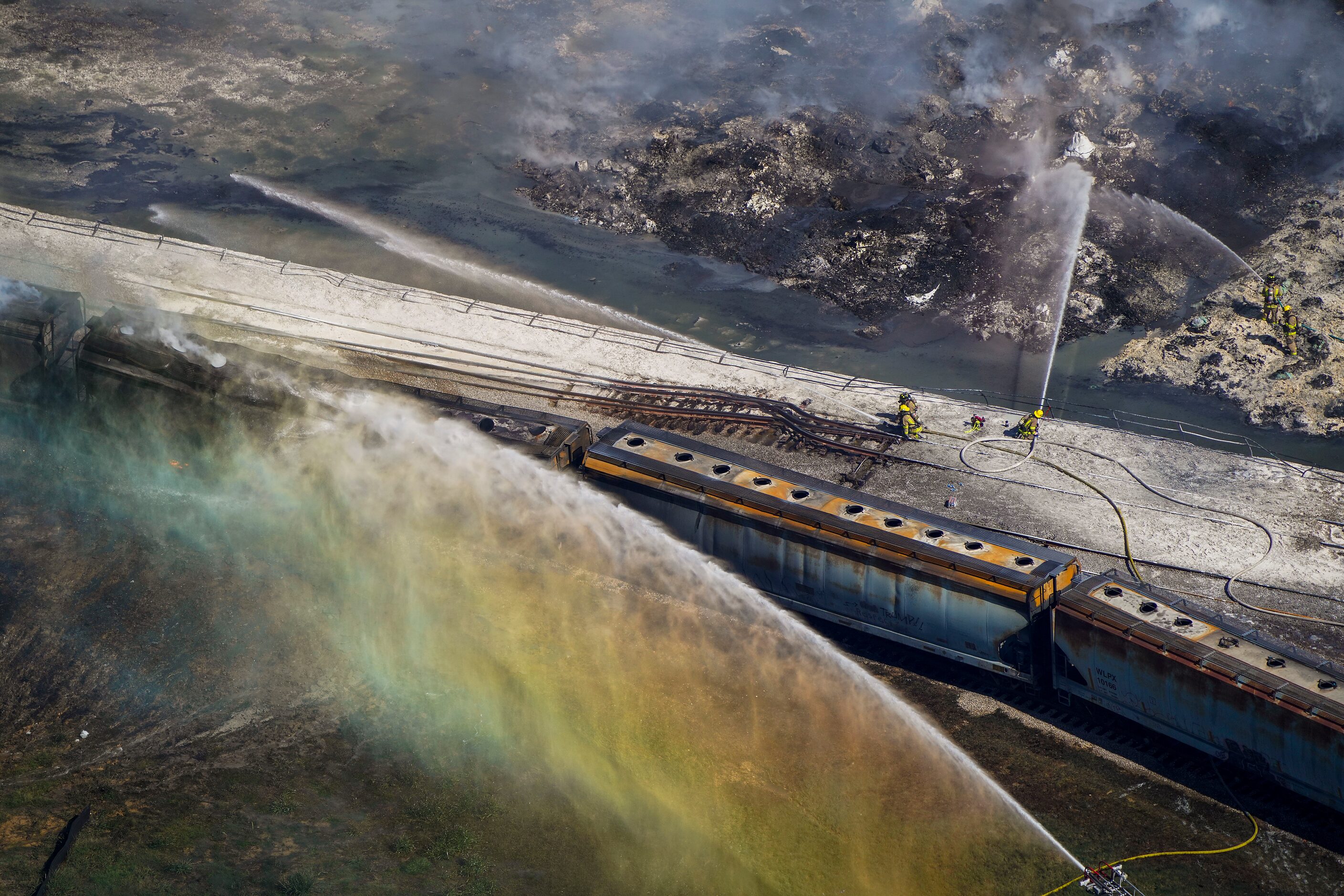 Aerial view of fire crews working at the site of a massive blaze in an industrial area on...