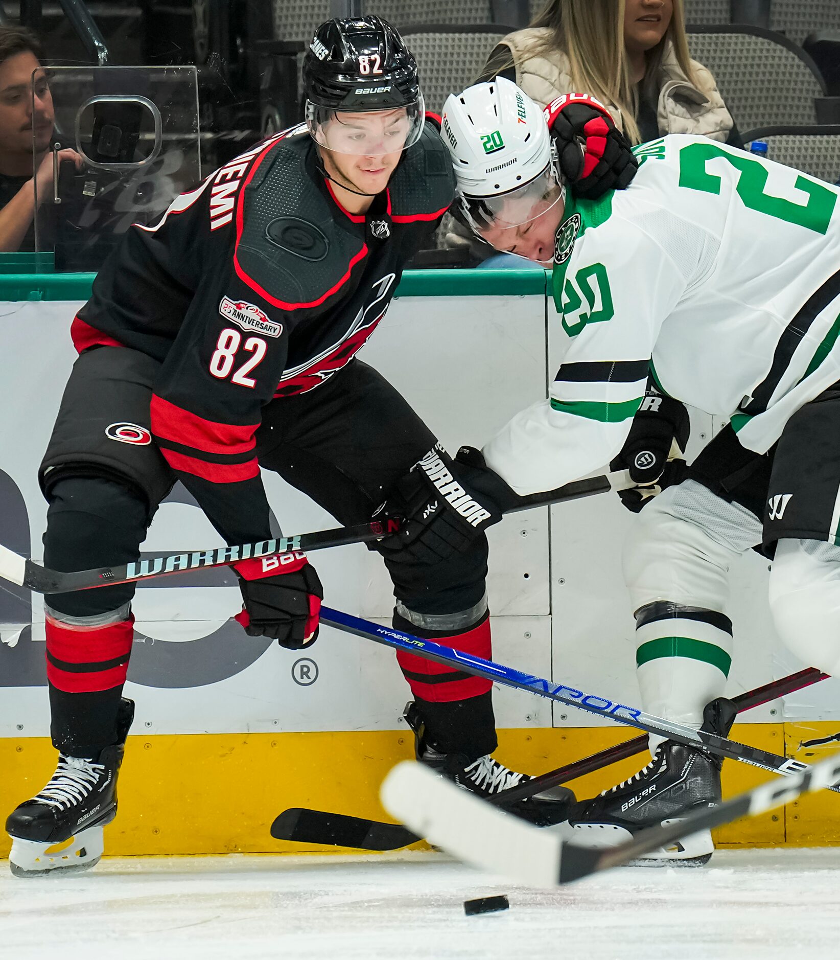 Dallas Stars defenseman Ryan Suter (20) has his helmet knocked off as he fights for the puck...