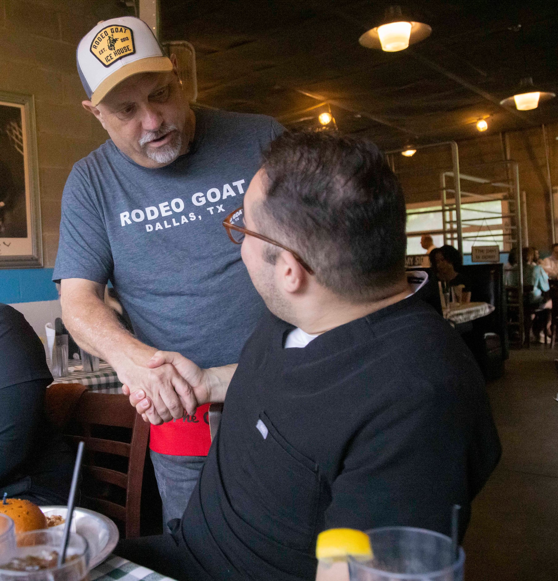 (From left) The Dallas Morning News’ Rangers reporter Evan Grant shakes Gustavo Rangel’s...