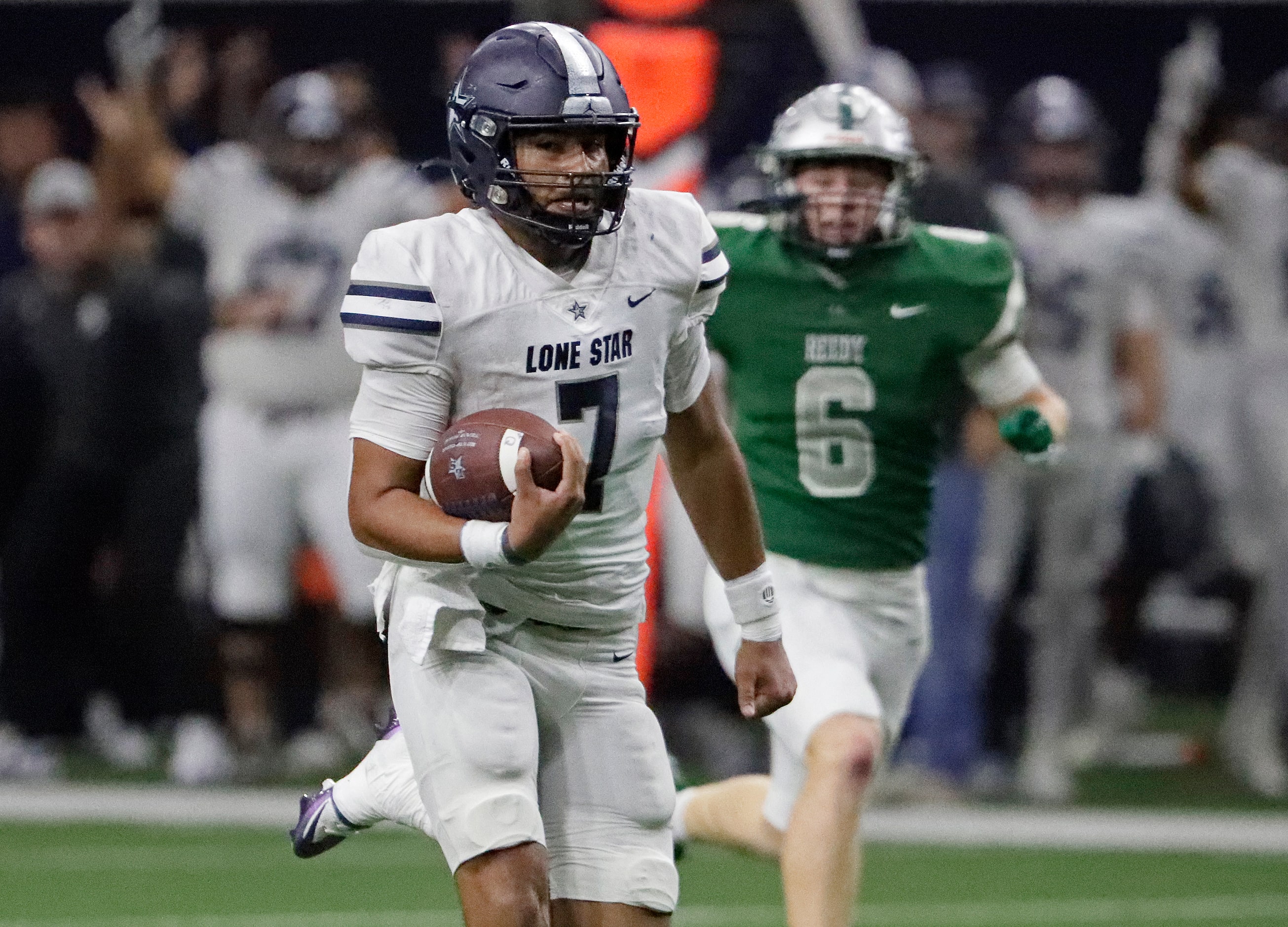 Lone Star High School quarterback Karece Hoyt (7) is chased by Reedy High School defensive...