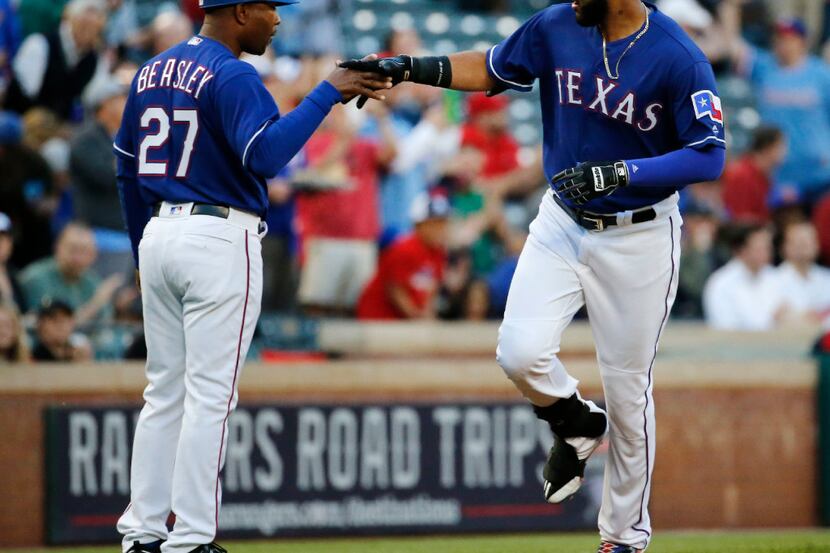 Texas Rangers right fielder Nomar Mazara (30) shakes hands with Texas Rangers third base...