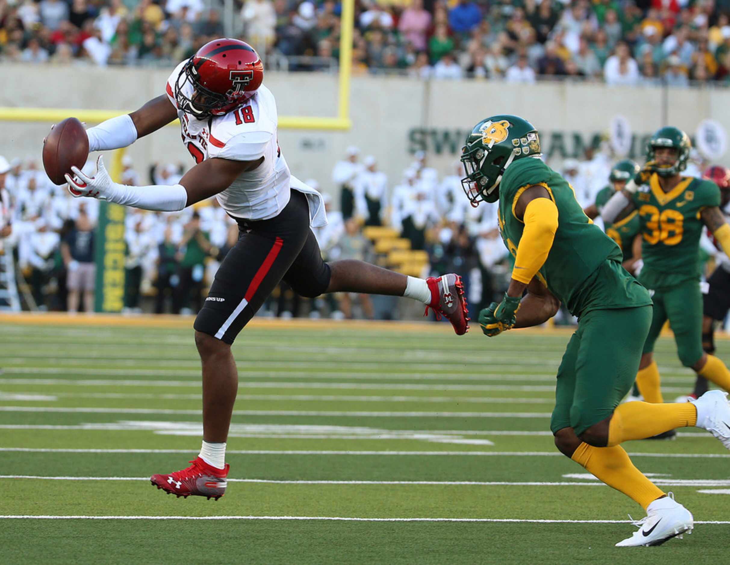 Texas Tech wide receiver Cameron Cantrell (18) catches a pass in front of Baylor safety...